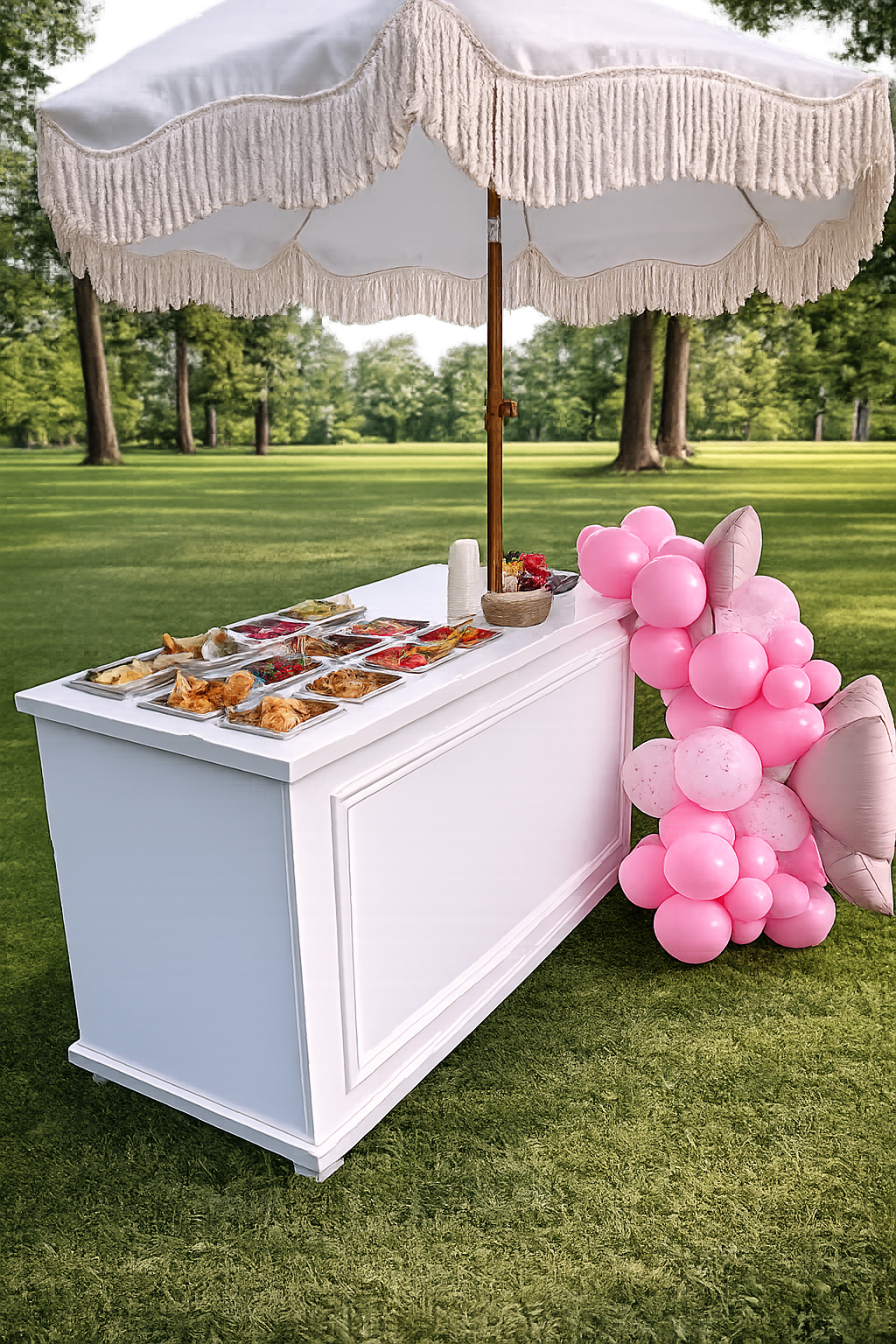 Angled view of the candy cart with pink balloons and white parasol