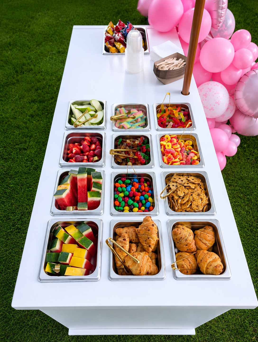 Top view of the candy cart with sweets, fruit and pastries