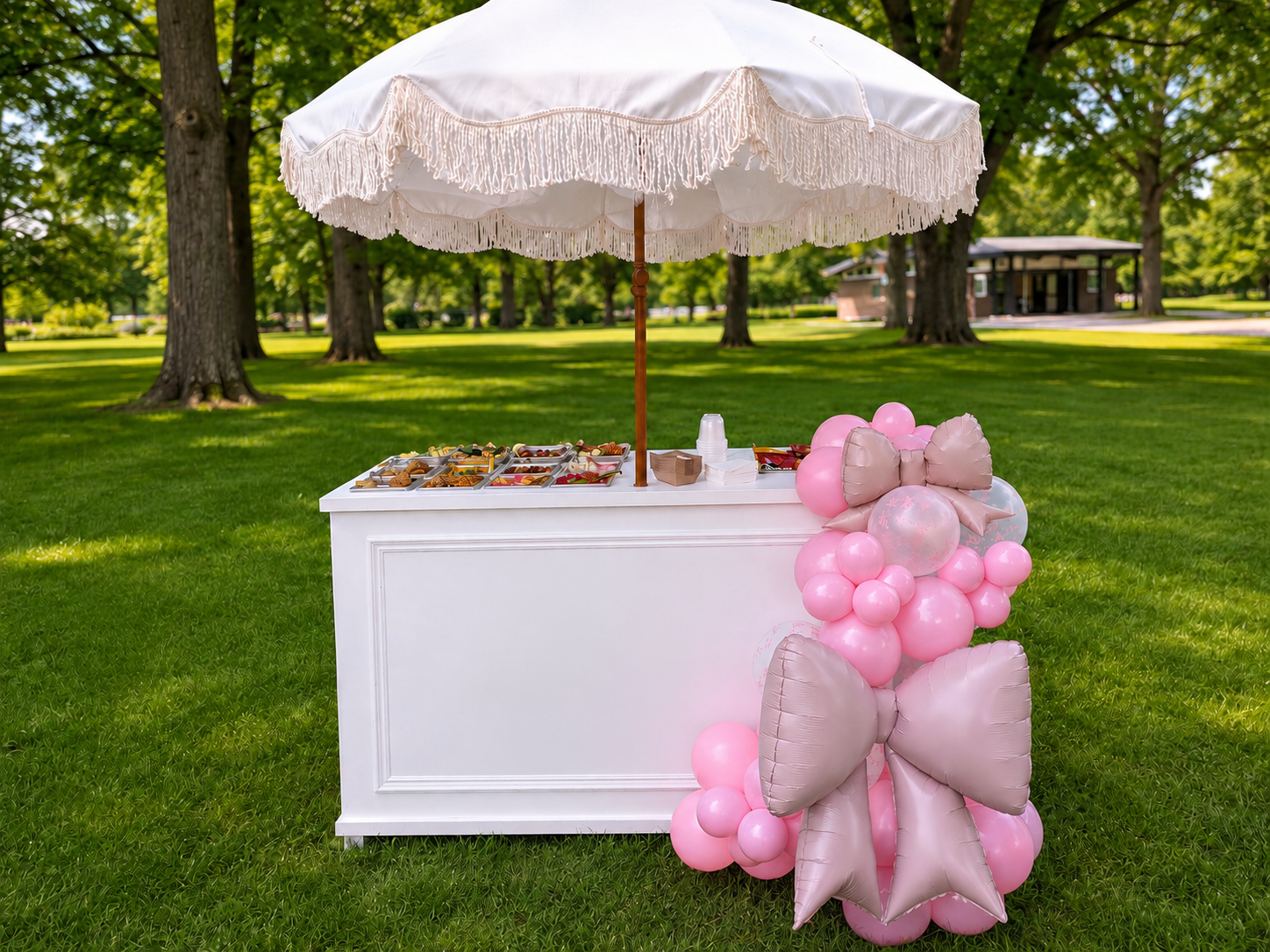 Le Graze Bar candy cart styled outdoors with pink balloon décor